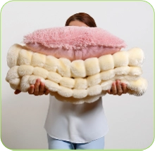 Woman holding a stack of colorful Warp Knit Fabric rolls