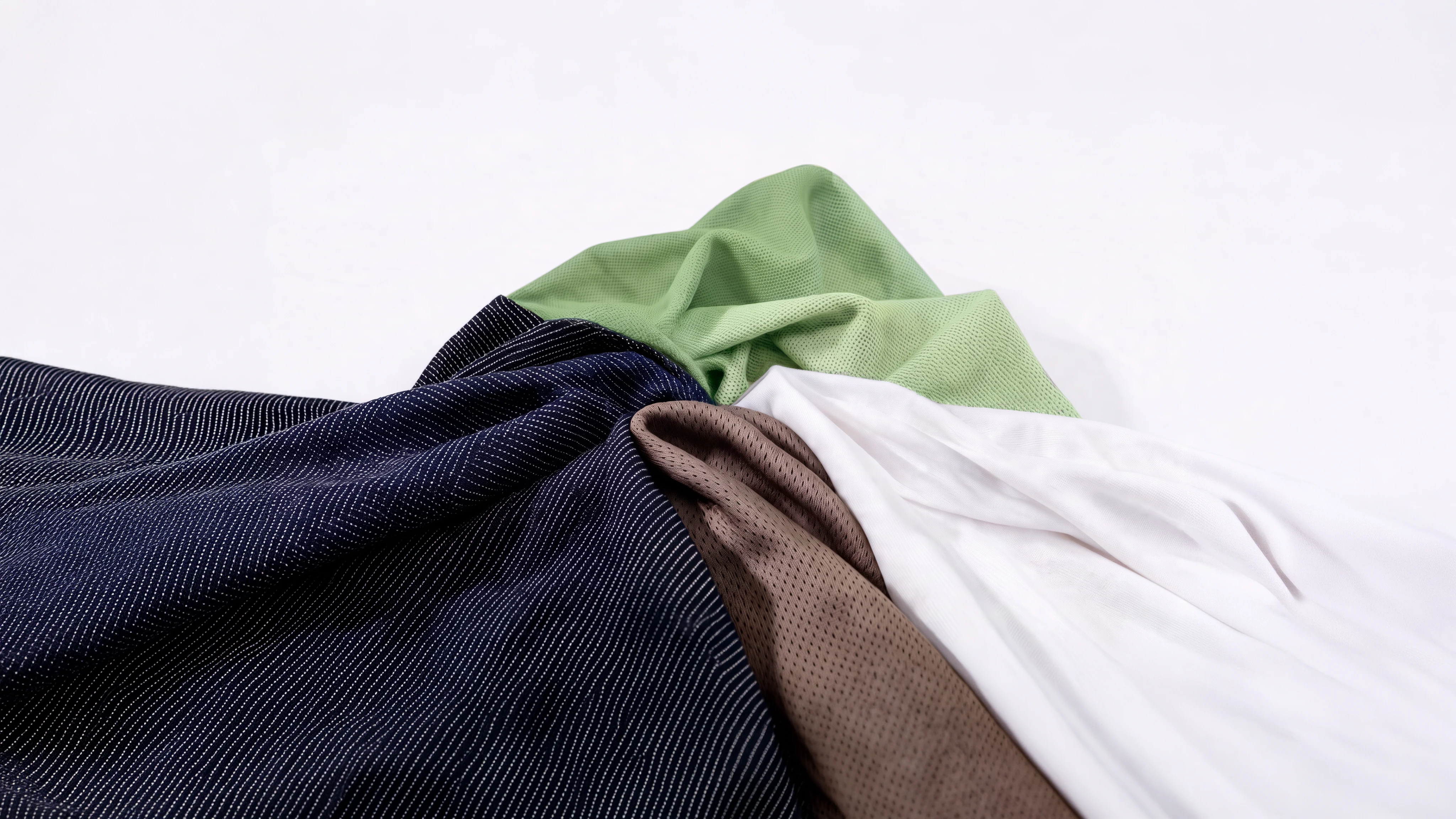 Stacked recycled polyester fabrics in varied constructions and colours